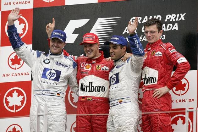 Siegerehrung: v.li.: Ralf Schumacher (BMW-Williams), Michael Schumacher (beide Deutschland Ferrari), Juan Pablo Montoya (Kolumbien BMW-Williams) und Renningenieur Chris Dyer (Australien Ferrari) Motorsport Grand Prix Herren Großer Preis von Kanada 2003, Formel 1 Weltmeisterschaft, F1, F, GP, WM, Vdig Gruppe Montreal Freude,