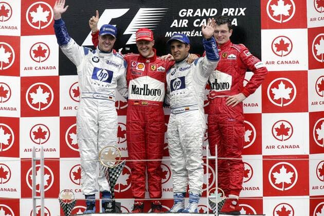Siegerehrung, v. li.: Ralf Schumacher (BMW-Williams), Michael Schumacher (beide Deutschland Ferrari), Juan Pablo Montoya (Kolumbien BMW-Williams) und Renningenieur Chris Dyer (Australien Ferrari) Motorsport Grand Prix Herren Großer Preis von Kanada 2003, Formel 1 Weltmeisterschaft, F1, F, GP, WM, Vdig Gruppe Montreal