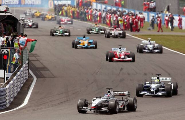 Kimi Räikkönen (vorn, Finnland McLaren-Mercedes) führt das Feld vor Ralf Schumacher (Deutschland BMW-Williams) an Motorsport Grand Prix Herren Großer Preis von England 2003, Formel 1 Weltmeisterschaft, F1, F, GP, WM, Totale Silverstone