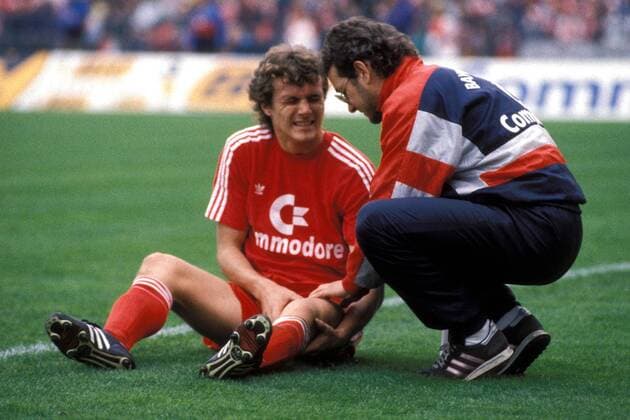 Roland Grahammer lässt sich das schmerzende Knie von Physiotherapeut Wolfgang Gebhardt (beide Bayern) behandeln Fußball 1. BL Herren Saison 1988 1989, FC Bayern München, Vdia Gruppe München