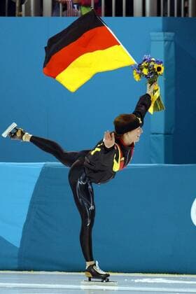 Olympiasiegerin Claudia Pechstein (Deutschland) posiert auf der Ehrenrunde mit Blumenstrauß und Deutschlandfahne als Eiskunstläuferin Eisschnellauf OS Winter Damen Olympische Winterspiele 2002, Olympia, Olympiade, Spiele, Eisschnellaufen, Eisschnelllaufen, Einzelbild Salt Lake City Utah Glück, Freude,