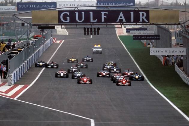 Kurz nach dem Start zum GP von Bahrain 2004 führt Michael Schumacher (2.v.re., Deutschland) bereits das Feld an vor Teamkollege Barrichello (Brasilien beide Ferrari) Motorsport Grand Prix Herren Großer Preis von Bahrain 2004, Formel 1 Weltmeisterschaft, F1, F, GP, WM, Totale Bahrain Racing Circuit Manama