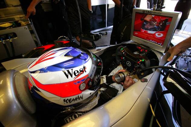 Kimi Räikkönen (Finnland McLaren-Mercedes) beobachtet seinen Konkurrenten Michael Schumacher (Deutschland Ferrari) auf dem Monitor in der Box Motorsport Grand Prix Herren Großer Preis der USA 2004, Formel 1 Weltmeisterschaft, F1, F, GP, WM, Vdig, Qualifying Einzelbild Indianapolis Speedway Indianapolis