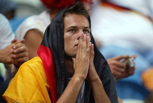 Deutscher Fan enttäuscht in der Nationalfahne eingehüllt Fußball EM Herren Euro 2004, Europameisterschaft, Länderspiel, Nationalmannschaft, Nationalteam, Gruppe D Einzelbild Lissabon Enttäuschung,