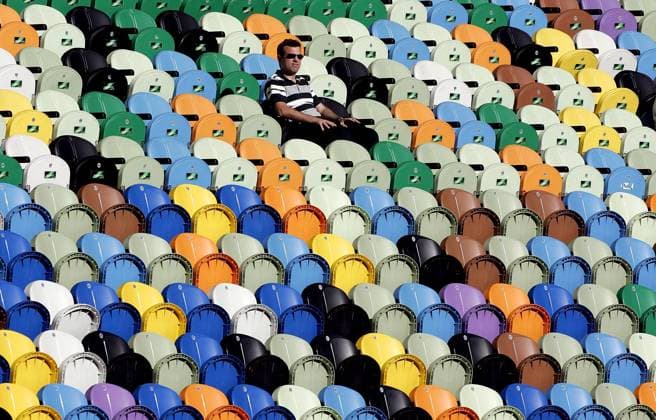 Ein Fan sitzt allein auf den bunten Plastiksitzen und verfolgt das Geschehen Fußball EM Herren Euro 2004, Europameisterschaft, Länderspiel, Nationalmannschaft, Nationalteam, Viertelfinale, Vdig Einzelbild Lissabon