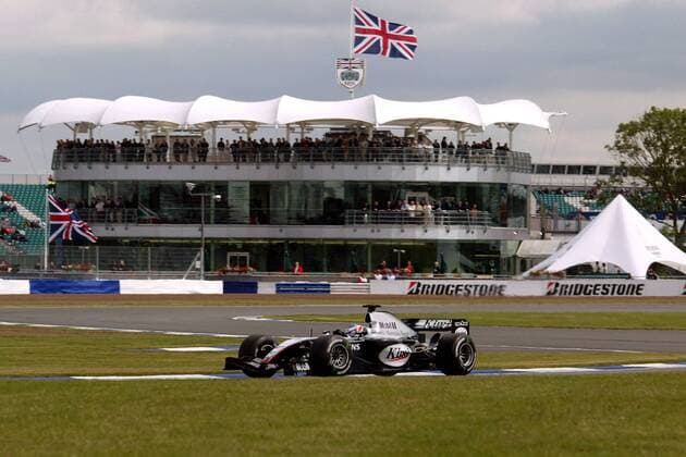 Kimi Räikkönen (Finnland McLaren-Mercedes) in seinem Rennwagen vor der Haupttribüne Motorsport Grand Prix Herren Großer Preis von England 2004, Formel 1 Weltmeisterschaft, F1, F, GP, WM, freies Training, Totale Silverstone
