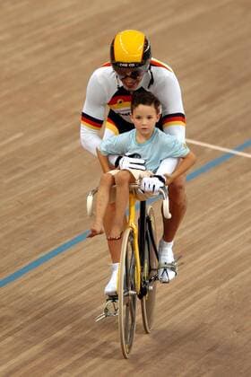 Olympiasieger Jens Fiedler (Deutschland) dreht mit Sohn Ramon Noel eine Ehrenrunde Radsport OS Sommer Herren Olympische Sommerspiele Athen 2004, Olympia, Olympiade, Spiele, Rad, Bahn, Bahnrad, Bahnradsport, Gruppe Maroussi Freude,