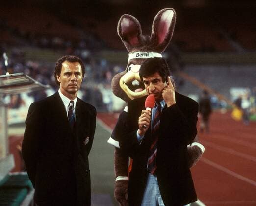 Teamchef Franz Beckenbauer (li., BR Deutschland) im Gespräch mit ARD Reporter Werner Zimmer, dahinter das EM Maskottchen Berni Fußball EM Herren DEUTSCHSPRACHIGE SPORTZEITSCHRIFTEN UND -ZEITUNGEN NUR NACH RÜCKSPRACHE, Europameisterschaft 1988 Gruppe öffentlich rechtliche Düsseldorf