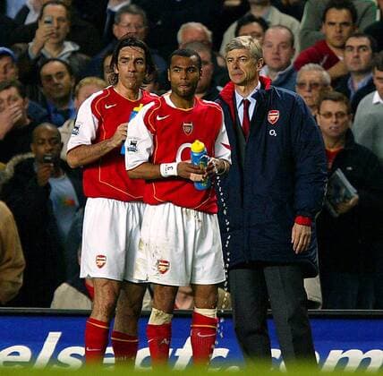 Trainer Arsene Wenger (re.) steht mit Ashley Cole (Mitte) und Robert Pires (alle Arsenal) am Spielfeldrand -  Fußball Herren English Premier League 2004 2005, 1. Englische Liga, Arsenal FC London Gruppe London Skepsis,