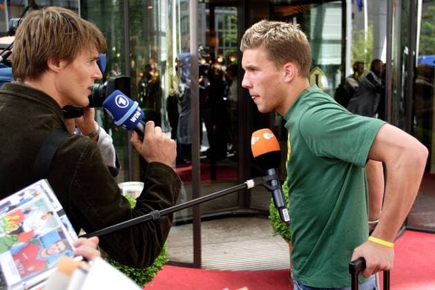 Lukas Podolski (Deutschland, re.) gibt bei der Ankunft am Frankfurter Hotel ARD Reporter Dietmar Teige ein Interview Fußball Herren Confederations Cup 2005, Confederationscup, Konföderationen, Konföderationencup Gruppe Frankfurt M.