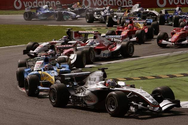 Kurz nach dem Start zum GP von Italien 2005: Juan Pablo Montoya (Kolumbien McLaren Mercedes) führt in der ersten Kurve vor Fernando Alonso (Spanien Renault) und Jenson Button (England BAR Honda) Motorsport Grand Prix Herren Großer Preis von Italien 2005, Formel 1 Weltmeisterschaft, F1, F, GP, WM Totale Monza
