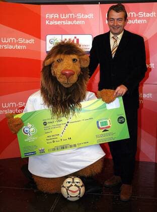 Präsentation der offiziellen Tickets zur Weltmeisterschaft 2006: OK Vizepräsident Wolfgang Niersbach (Deutschland) präsentiert mit Maskottchen Goleo VI und Pille der sprechende Ball ein überdimensionales Muster für die Partie Italien - USA Fußball WM Herren Vorschau Weltmeisterschaft 2006, Vorstellung, Präsentation, Pressetermin, Vdig Gruppe Kaiserslautern