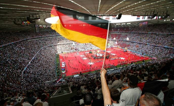 Die Deutschlandfahne dominiert das Bild während der Eröffnungsfeier der Fußball WM 2006 im World Cup Stadium München -  Fußball WM Herren Eröffnungsfeier 2006, Eröffnung, Feier, Zeremonie, Choreographie Totale Seil, Seile, schweben München