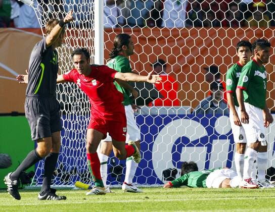 Yahya Golmohammadi (Iran, 2.v.li.) dreht jubelnd ab, während Schiedsrichter Roberto Rosetti (Italien) die Richtung anzeigt, die Spieler von Mexiko dahinter sind enttäuscht -  Fußball WM Herren WM 2006, Länderspiel, Nationalteam, Gruppe D, Iran - Mexiko 1:3 Gruppe Nürnberg Enttäuschung, Freude,