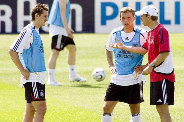 Bundestrainer Jürgen Klinsmann (re.) während des Trainings im Gespräch mit seinen Stürmern Lukas Podolski (Mitte) und Miroslav Klose (alle Deutschland) Fußball Herren WM 2006, Nationalteam, Training, Gruppe Berlin