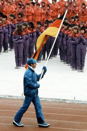 Fahnenträger Frank Ullrich (DDR) führt die Delegation der DDR während der Eröffnungsfeier der Olympischen Winterspiele 1984 in Sarajevo an Biathlon OS Winter Herren Olympische Spiele 1984, Winterspiele, Eröffnung, Zeremonie, Eröffnungszeremonie, Einzelbild Sarajevo