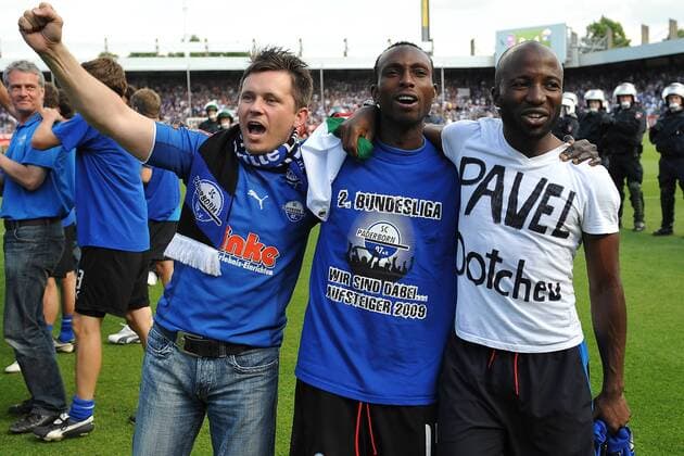 Dominick Kumbela (re.) widmet den Aufstieg dem kürzlich entlassenen Übungsleiter Pavel Dotchev, Rolf Christel Guie Mien (beide Paderborn) feiert mit einem Fan Fußball 2. BL Herren Saison 2008 2009, Relegation, Relegationsspiel, SC Paderborn 07 Gruppe Osnabrück Freude,