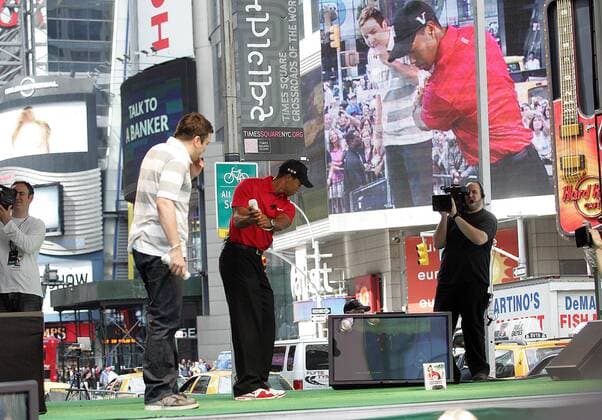 Tiger Woods (USA, Mitte) spielt mit Schauspieler Jimmy Fallon (li.) am Time Square in New York Tiger Woods PGA Tour 10 Wii Golf -  (NYP20090625228) Golf Herren E Sports 2009, Spiel Computerspiel, Simulation, Computersimulation, Videospiel o0 esports Gruppe Promotiontermin New York, NY, N.Y.