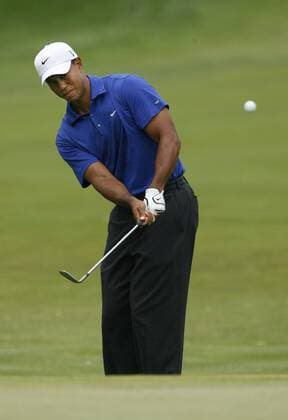 Tiger Woods chips up onto the first green at Hazeltine National Golf Club in Chaska, on August 15, 2009.  BKX2009081532