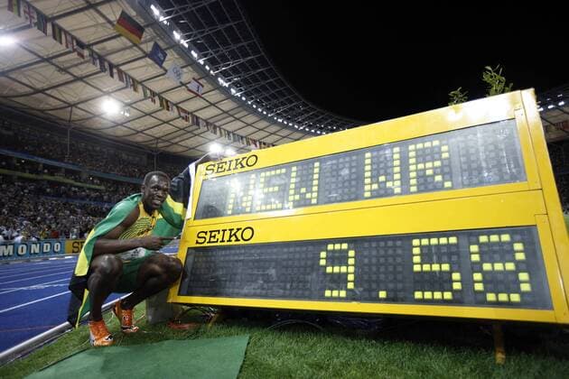 Jamaica s Usain Bolt celebrates beside the result board after winning the men s 100m final. Bolt set a new world record with a time of 9.58 seconds and claimed the title of the event. 