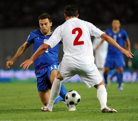 Giuseppe Rossi (L) of Italy vies with a player of Georgia 