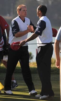 United States team member Tiger Woods (R) and Steve Stricker celebrate after winning their match during the second round of The Presidents Cup at Harding Park Golf Course in San Francisco, California on October 9, 2009.  SFP20091009316 o0 USA, Eldrick o00 The President s