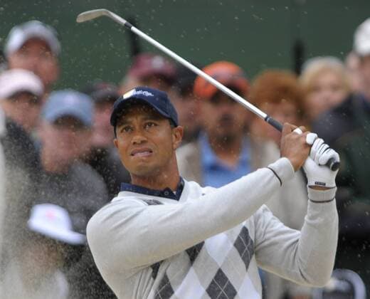 United States team member Tiger Woods hits out of a bunker on the 2nd hole during the third round of The Presidents Cup .  SFP20091010303 o0 USA