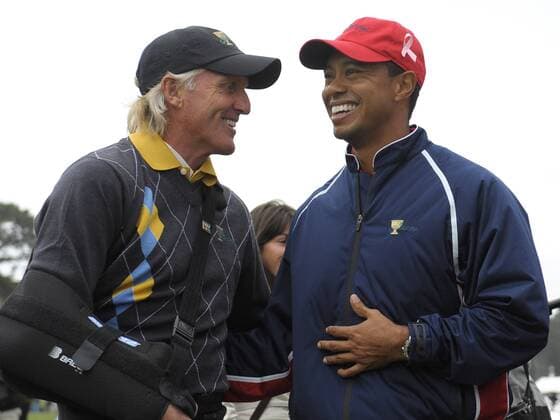 International team captin Greg Norman (Australia, L) talks to United States team member Tiger Woods (USA) -  SFP20091011327 o0 Eldrick o00 President s
