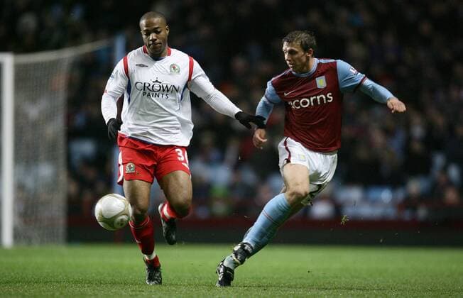 Stephen Warnock of Aston Villa (R) clears the ball ahead of Macacieo Rigters of Blackburn EON FA Cup 3rd Round Aston Villa v Blackburn Rovers 2nd January, 2010 EDITORIAL USE ONLY. No use with unauthorised audio, video, data, fixture lists, club league logos or live services. Online in-match use limited to 120 images, no video emulation. No use in betting, games or single club league player publications.