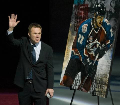 Former Colorado Avalanche and New Jersey Devils Claude Lemieux waves while being honored for alumni appreciation night before the first period between New Jersey and Colorado at the Pepsi Center in Denver on January 16, 2010. Lemieux won four Stanley Cups while playing for three different teams.  DEN20101606