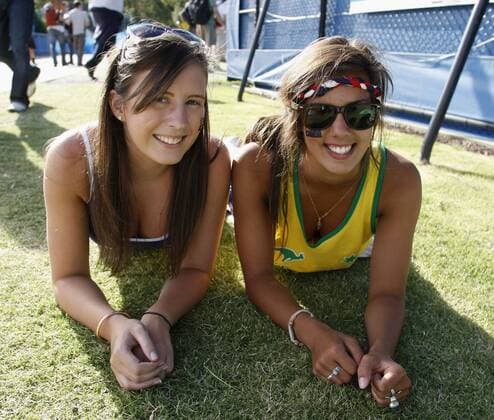 Australien, Melbourne, Sport, Tennis, Grand Slam Tournament, Melbourne Park, Australian Open 2010, zwei hübsche weibliche Tennis Fans relaxen auf dem Rasen neben dem Court. o0 Freude