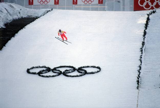 Skispringer fliegt über die Olympischen Ringe hinweg - während der Olympischen Winterspiele 1992 in Albertville Skispringen OS Winter Herren Olympische Winterspiele 1992, Olympia, Spiele, Ski Nordisch, Skisport, Totale Albertville o0 Courchevel