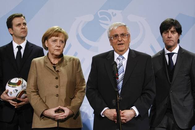 Berlin, den 10.02.2010 - Bundeskanzleramt, Übergabe eines signierten WM Trikots 2010 an Bundeskanzlerin Angela Merkel, v.l.n.r. Teammanager Oliver Bierhoff, Bundeskanzlerin Angela Merkel, DFB Präsident Dr. Theo Zwanziger und Bundestrainer Joachim Löw (alle GER) Fußball Vorschau WM 2010 Berlin