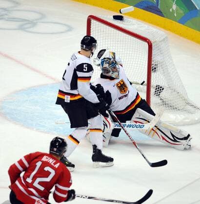 Canada s Jarome Iginla (L) scores against Germany s Thomas Greiss (R) as Germany s Korbinian Holzer defends during the second period at Canada Hockey Place in Vancouver, Canada, during the 2010 Winter Olympics on February 23, 2010. -  OLY2010022386 o0 Tor