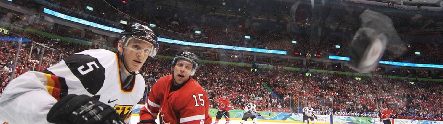 Canada s Dany Heatley and Germany s Korbinian Holzer (L) watch the puck during first period in the men s hockey qualification play-offs at Canada Hockey Place in Vancouver, BC during the 2010 Winter Olympics, February 23, 2010. - ZUMAw51 o0 Panoramabild