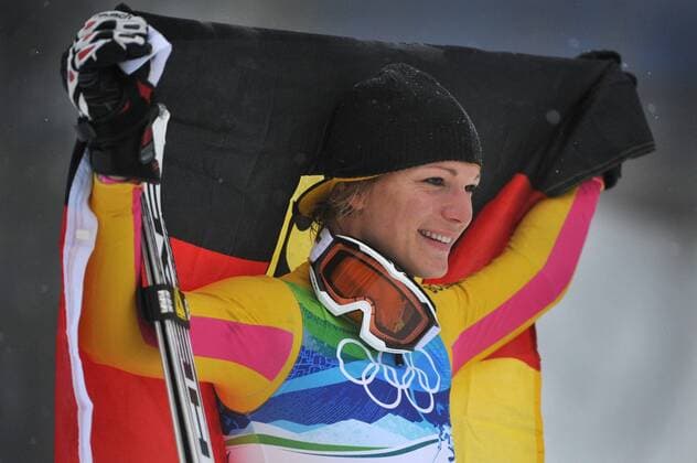 Germany s Maria Riesch celebrates with the Germany flag during the Ladies Slalom Flower Ceremony during the 2010 Vancouver Winter Olympics in Whistler, Canada on February 26, 2010.  OLY20100226332 o0 Olympiasieg Sieg Freude Jubel Fahne, Landesfahne Objekte
