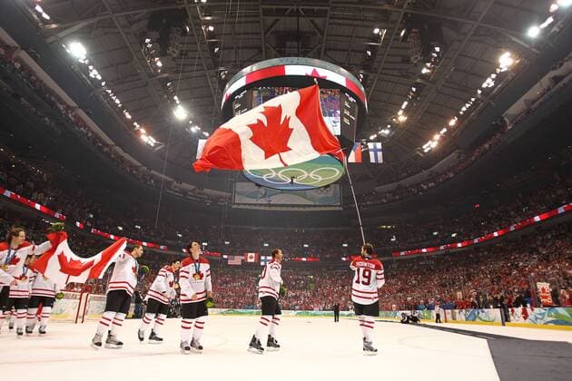 Feb 28, 2010 - Vancouver, British Columbia, Canada - Team Canada takes a victory lap around the rink at Canada Hockey Place after receiving their gold medals during the 2010 Winter Olympics.  - ZUMA o0 Sieg, Sieger, Olympiasieg, Olympiasieger, Fahne, Nationalfahne, Objekte Jubel Freude