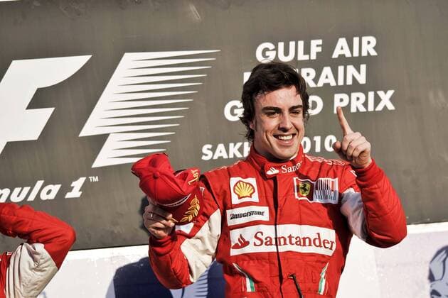 (100314) -- MANAMA, March 14, 2010 () -- Ferrari s Spanish driver Fernando Alonso gestures on the podium after winning the Bahrain F1 Grand Prix at Sakhir circuit in Manama March 14, 2010. Alonso won his Ferrari debut with 1h 39m 20.396s.  o0 Sieg, Sieger Jubel freude