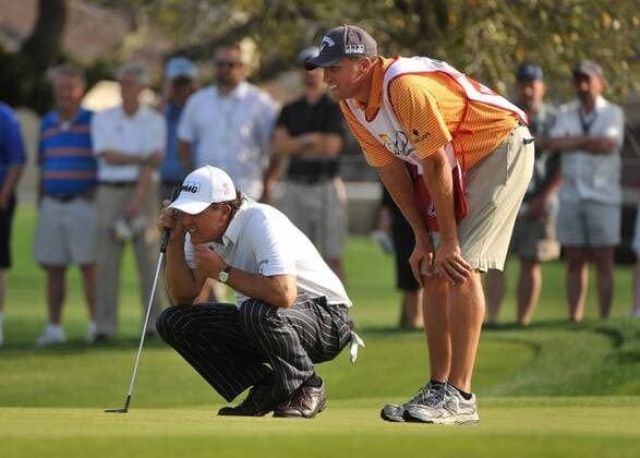 Phil Mickelson (USA) and his caddie Jim Mackay line up a putt on the 13th green during the second round of the Arnold Palmer Invitational at the Bay Hill Club and Lodge in Orlando, Florida on March 26, 2010.  ORL20100326311