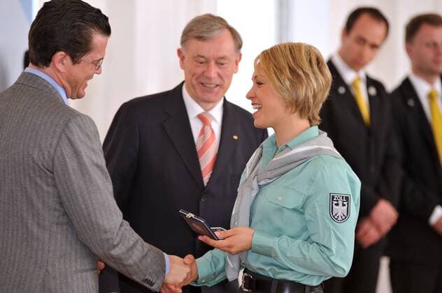 Magdalena Neuner, die Sportlerin bei der Auszeichnung mit dem Silbernen Lorbeerblatt für die Medaillengewinner der Olympischen Winterspiele 2010 mit Bundespräsident Horst Köhler Mitte und Verteidigungsminister Karl Theodor zu Guttenberg in Berlin am 30.04.2010 Verleihung Silberne Lorbeerblatt, Berlin, GER 2010  o0 Zoll Polizist