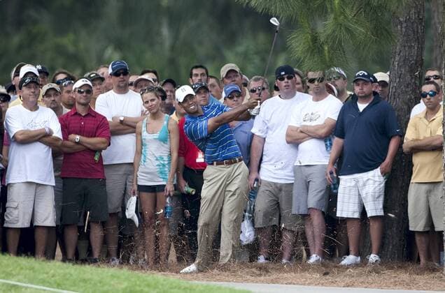 Tiger Woods (USA) hits out of the gallery after his first shot on the first hole went wide in the first round of The Players Championship PGA golf tournament in Ponte Vedra Beach -  PVB2010050607