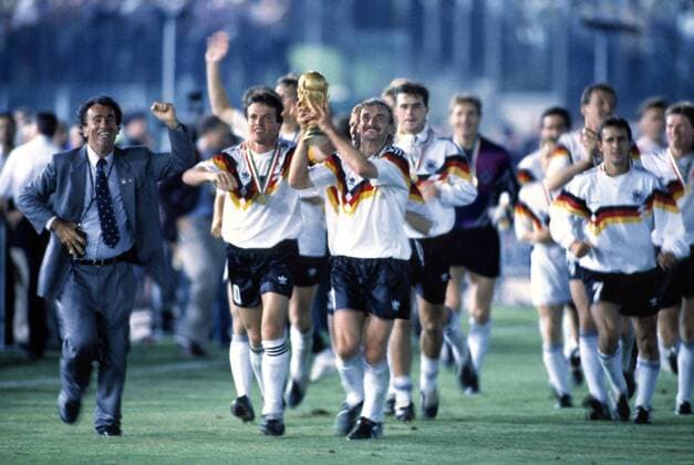 Lothar Matthaeus (left) and Rudi Voeller (GER) celebrate their victory with the trophy. Argentina v West Germany. World Cup Final 1990. Rome. 8 7 90.  o0 BRD BR