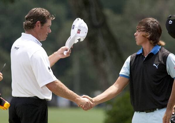 Lee Westwood, from Worksop, England, tips his hat to Rickie Fowler (USA), from Murrieta, CA., after finishing the second round of The Players Championship PGA golf tournament in Ponte Vedra Beach, Florida May 7, 2010. Westwood finished at twelve under par for the two days.  PVB2010050717