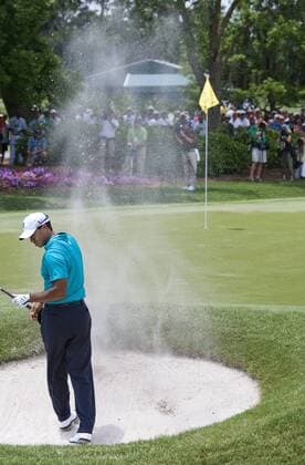 Tiger Woods (USA) turns away from the blowing sand after hitting out of a sand trap at the number nine green during the second round of The Players Championship PGA golf tournament in Ponte Vedra Beach, Florida May 7, 2010.  PVB2010050725