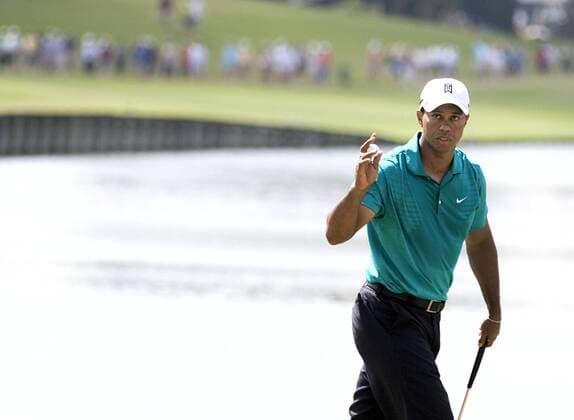 Tiger Woods (USA) acknowledges the spectators after finishing his first nine holes during the second round of The Players Championship PGA golf tournament in Ponte Vedra Beach, Florida May 7, 2010. Woods finished the second round at three under par.  PVB2010050715