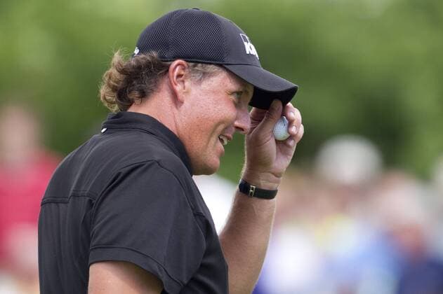 Phil Mickelson (USA) tips his cap after chipping in for birdie on the 14th hole during the final round of the Memorial Tournament held at Muirfield Village G.C. in Dublin, Ohio. Icon4391006067669 EDITORIAL USE ONLY