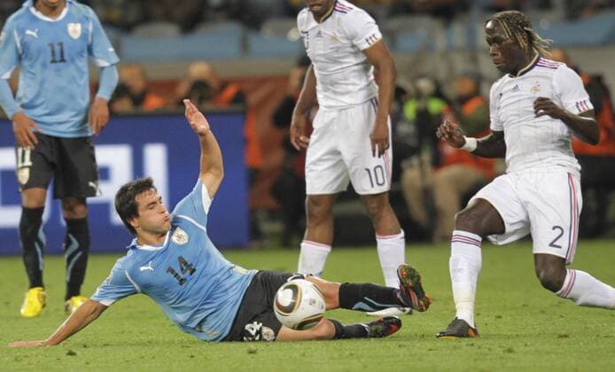 Nicolas Lodeiro (Bottom) of Uruguay defends Bacary Sagna (R) of France and is given the red card during a Group match of the 2010 FIFA World Cup between Uruguay and France in Cape Town, on June 11, 2010. The match ended with a 0-0 draw. - France (white) vs Uruguay -  Foul