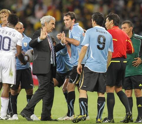 French coach Raymond Domenech (4th L) argues with Japanese referee Yuichi Nishimura (2nd R) during a Group match of the 2010 FIFA World Cup between Uruguay and France in Cape Town, on June 11, 2010. The match ended with a 0-0 draw. - France (white) vs Uruguay - 