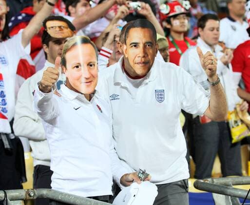 An England fan has a mask of Prime Minister David Cameron (ENGLAND, L) and a USA fan has one of President Barack Obama (USA) - FIFA World Cup 2010 - 12th June, 2010 EDITORIAL USE ONLY. No use with unauthorised audio, video, data, fixture lists, club league logos or live services. Online in-match use limited to 120 images, no video emulation. No use in betting, games or single club league player publications.
