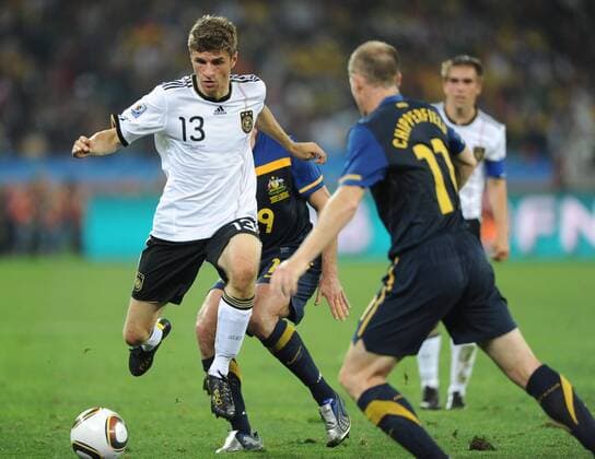 Thomas Müller (L) of Germany, Scott Chipperfield (Australia) during a Group D first round match against Australia 